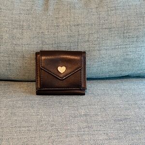 Claire’s black Leather mini wallet with heart accent.